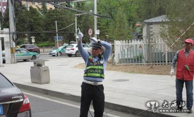 好交警托举电缆方便车辆通行